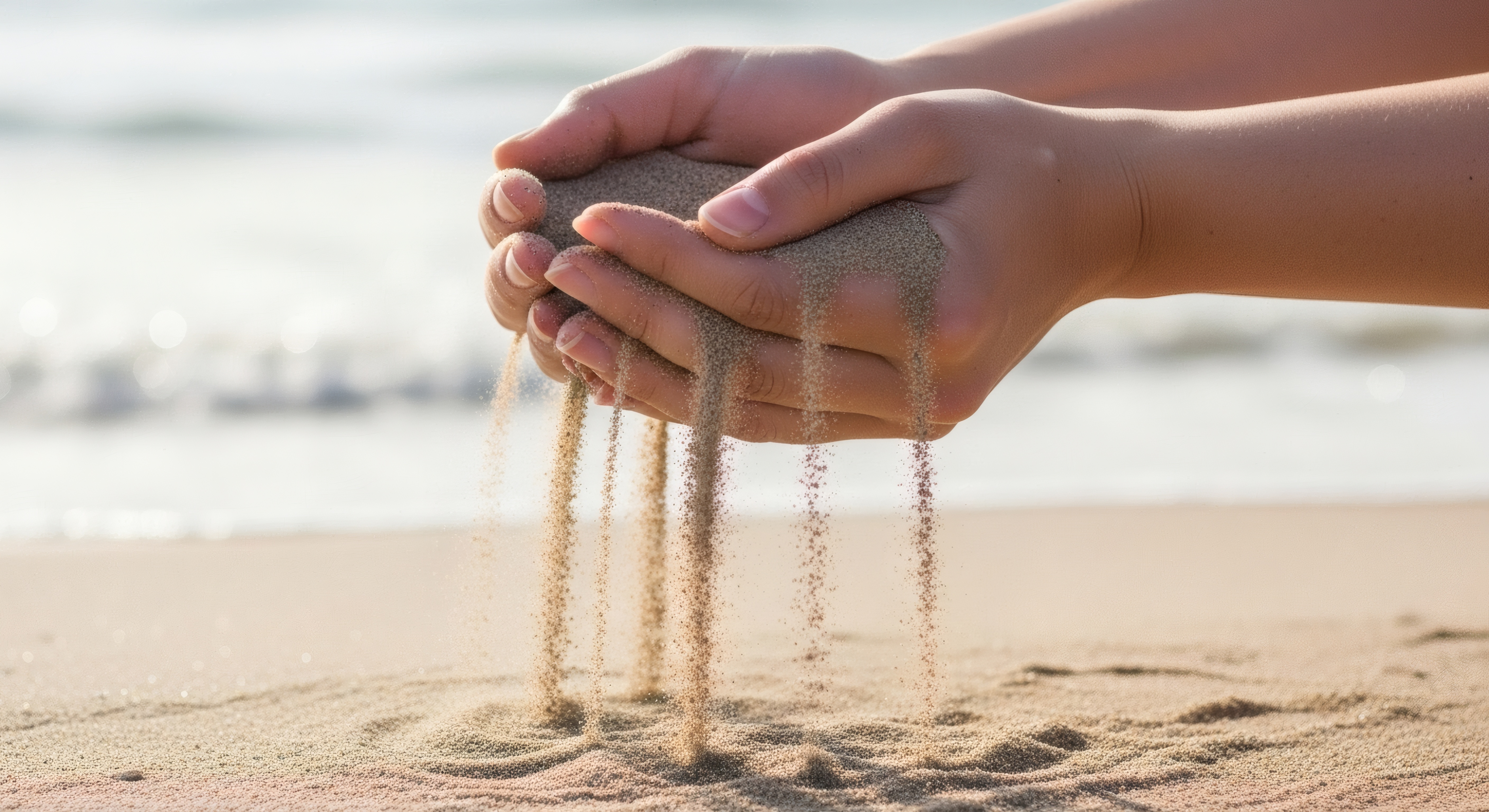 Sand slipping through fingers on beach summer vacation travel destination relaxing time at the beach concept